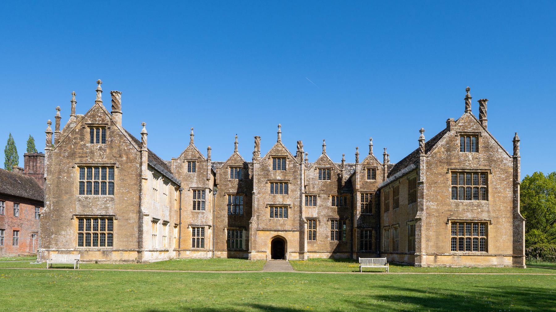 An English country house under a wide blue sky